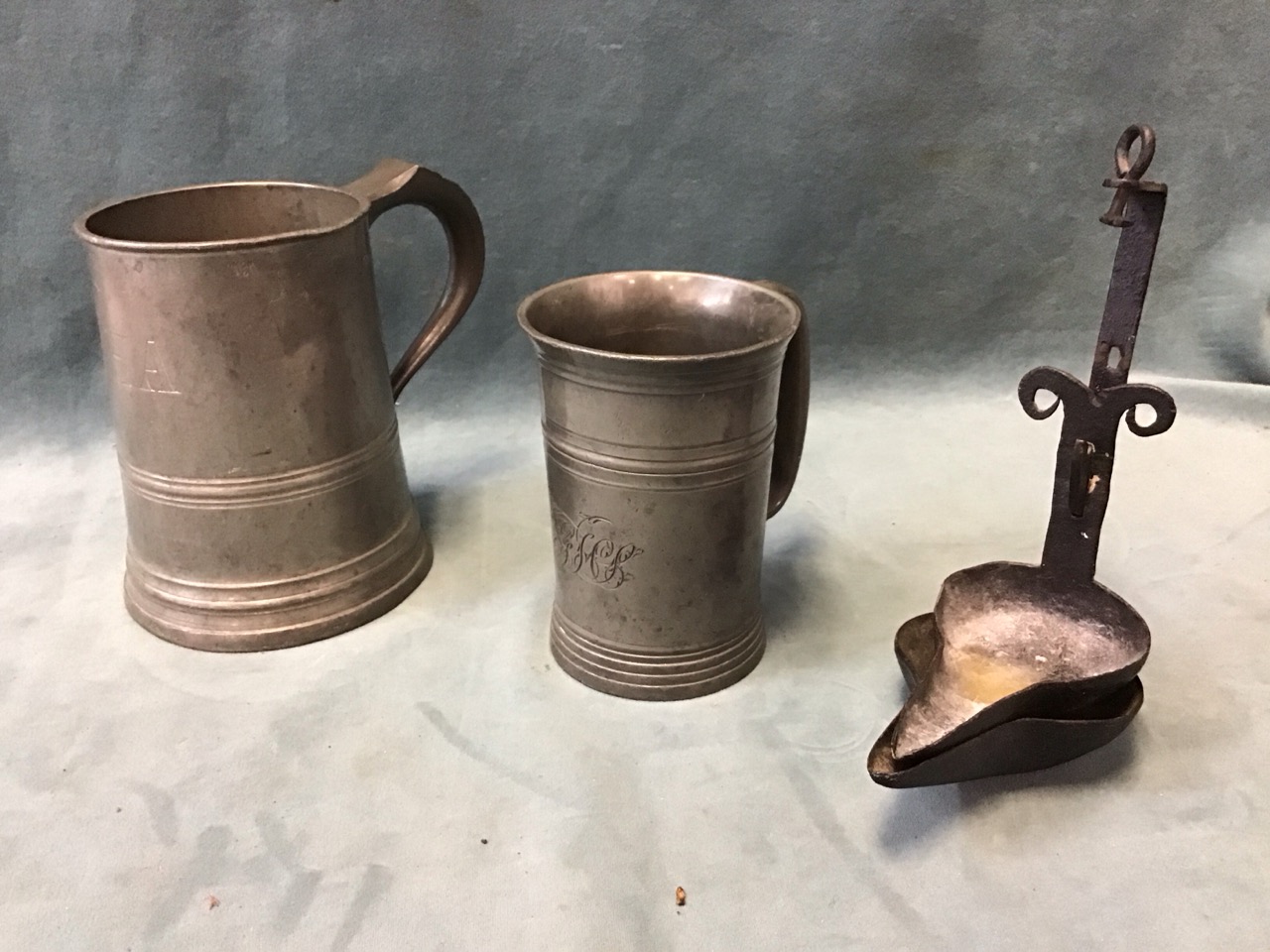 A Victorian pewter quart tankard with turned bands & engraved initials; an antique pewter flared