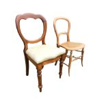 A Victorian mahogany balloon back chair with drop-in upholstered seat, raised on turned tapering