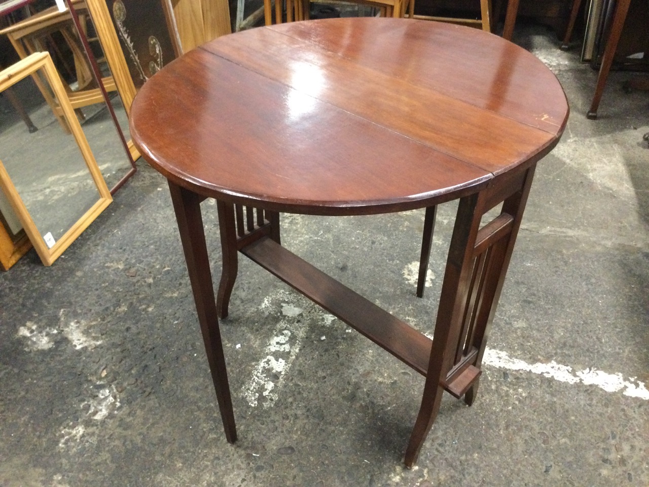 An Edwardian mahogany sutherland table with oval moulded top and two leaves supported on swing legs, - Image 2 of 3