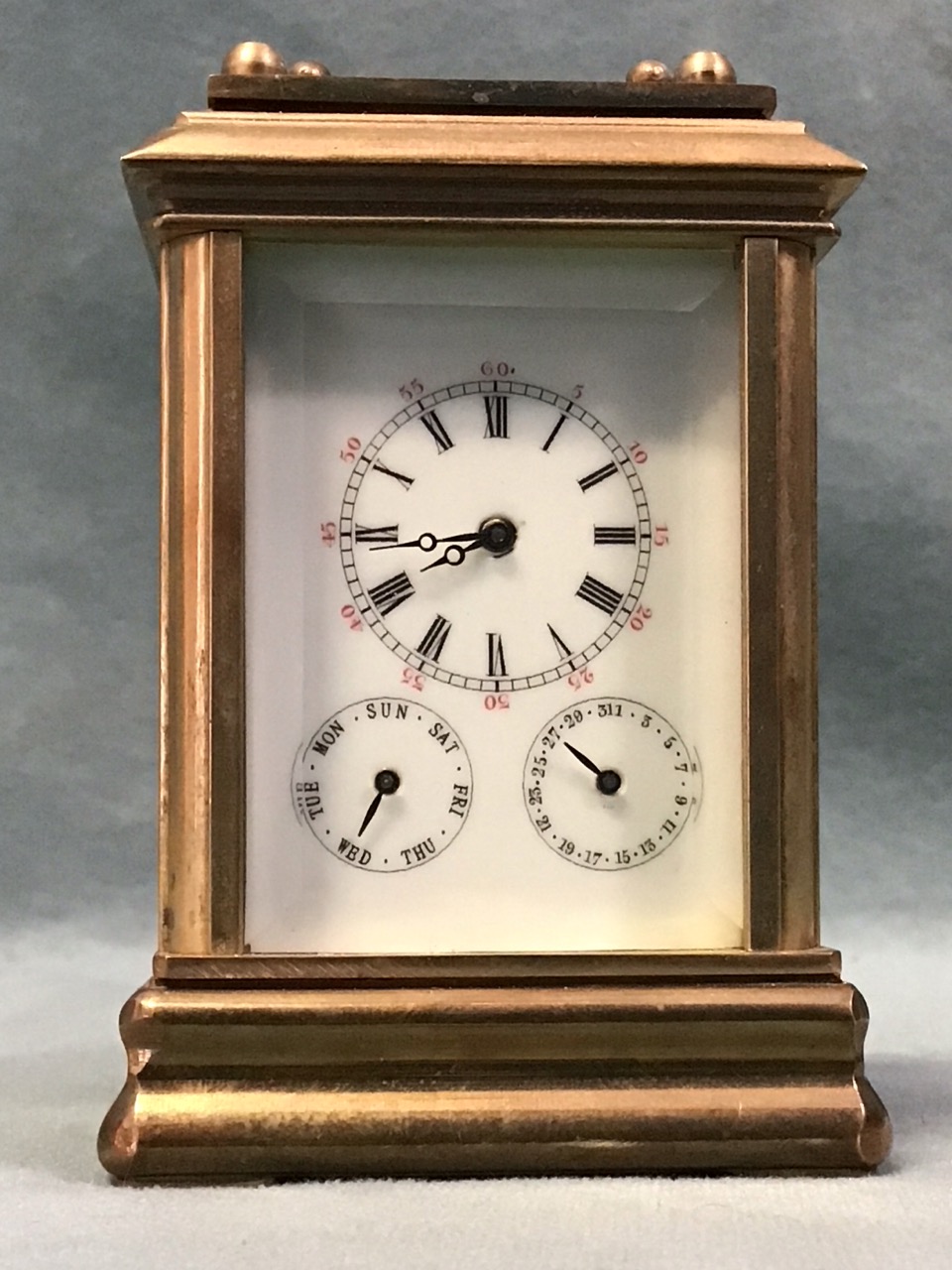 A miniature gilt brass corniche cased carriage clock with bevelled glass panels and enamelled dial - Image 2 of 3