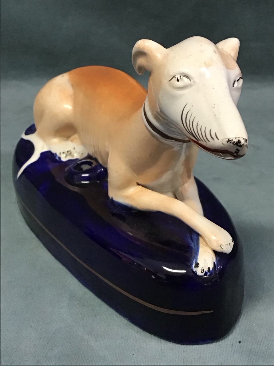 A Staffordshire ceramic inkwell in the form of a recumbent greyhound on an elliptical blue glazed - Image 2 of 3