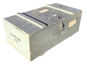 A rectangular painted hardwood trunk with battened top and metal hasp, stencilled with lettering and