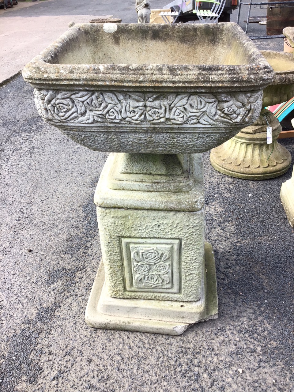 A square composition stone urn cast with frieze of roses above mottled body, supported on a square - Image 3 of 3