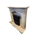 A faux limestone chimneypiece with rectangular mantlelshelf above a gothic shaped moulded aperture