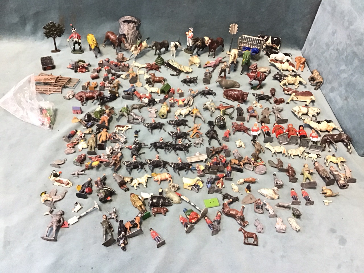 A collection of lead figures including soldiers, farm animals, knights, trees, street signs, etc. (A
