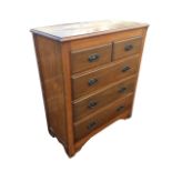 An Edwardian hardwood chest of drawers, the moulded rectangular top above two short and three long