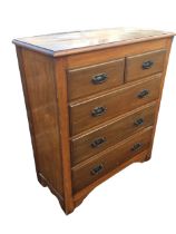 An Edwardian hardwood chest of drawers, the moulded rectangular top above two short and three long