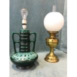 A Veritas brass oil lamp with twin wicks and milk glass globe shade framing glass chimney; and a 70s