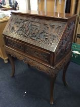 An Chinese hardwood bureau carved with panels of boats on a river, figures in landscapes &