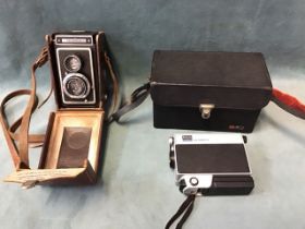 A leather cased Zeiss Ikon Ikoflex TLR camera; and a cased Kodak M24 Instamatic movie camera with