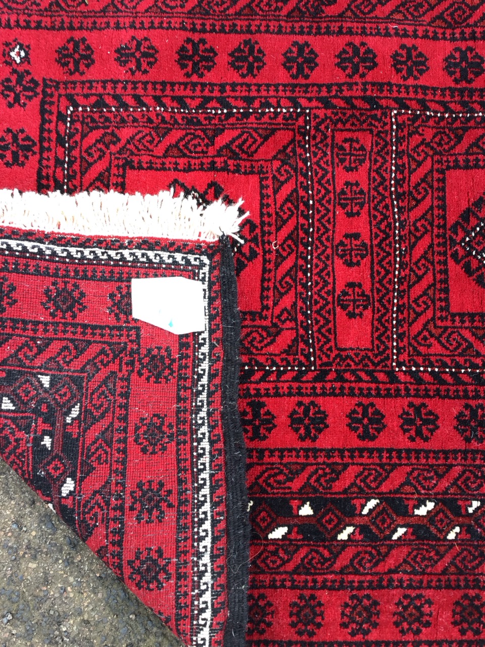 A Nahzat camel hair rug with three hooked medallions on a red ground within multiple flowerhead - Image 3 of 3