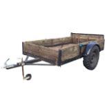 A large plank boarded box trailer with metal base and drop-side rear, having large pneumatic tyres