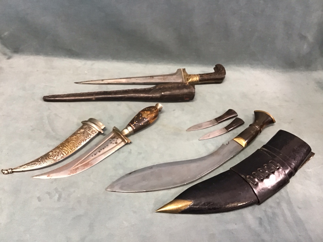 A Ghurka kukri, chakmak & karda knives with horn handles, brass fittings & leather faras sheath;