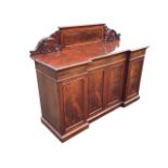 A Victorian mahogany inverted breakfront sideboard, the panelled back flanked by carved brackets,