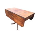 A regency mahogany dining table with rounded rectangular top and two leaves supported on brackets