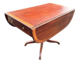 A regency mahogany pembroke table with rounded rectangular satinwood crossbanded top having two