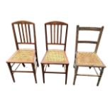 A pair of Edwardian mahogany chairs with arched backs inlaid with burr panels above slats and