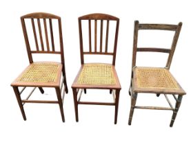 A pair of Edwardian mahogany chairs with arched backs inlaid with burr panels above slats and