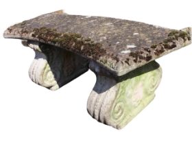 A crescent shaped composition stone garden seat with egg & dart cast slab seat on scrolled