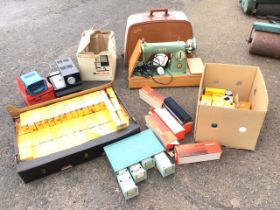 A 50s cased Alfa electric portable sewing machine; and a boxed Rank Aldis Tru-Lite QI 24 semi-
