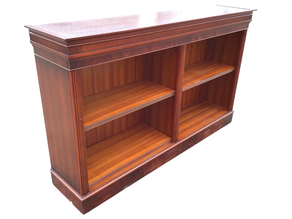 A Georgian style mahogany open bookcase with moulded ribbed cornice above two compartments with