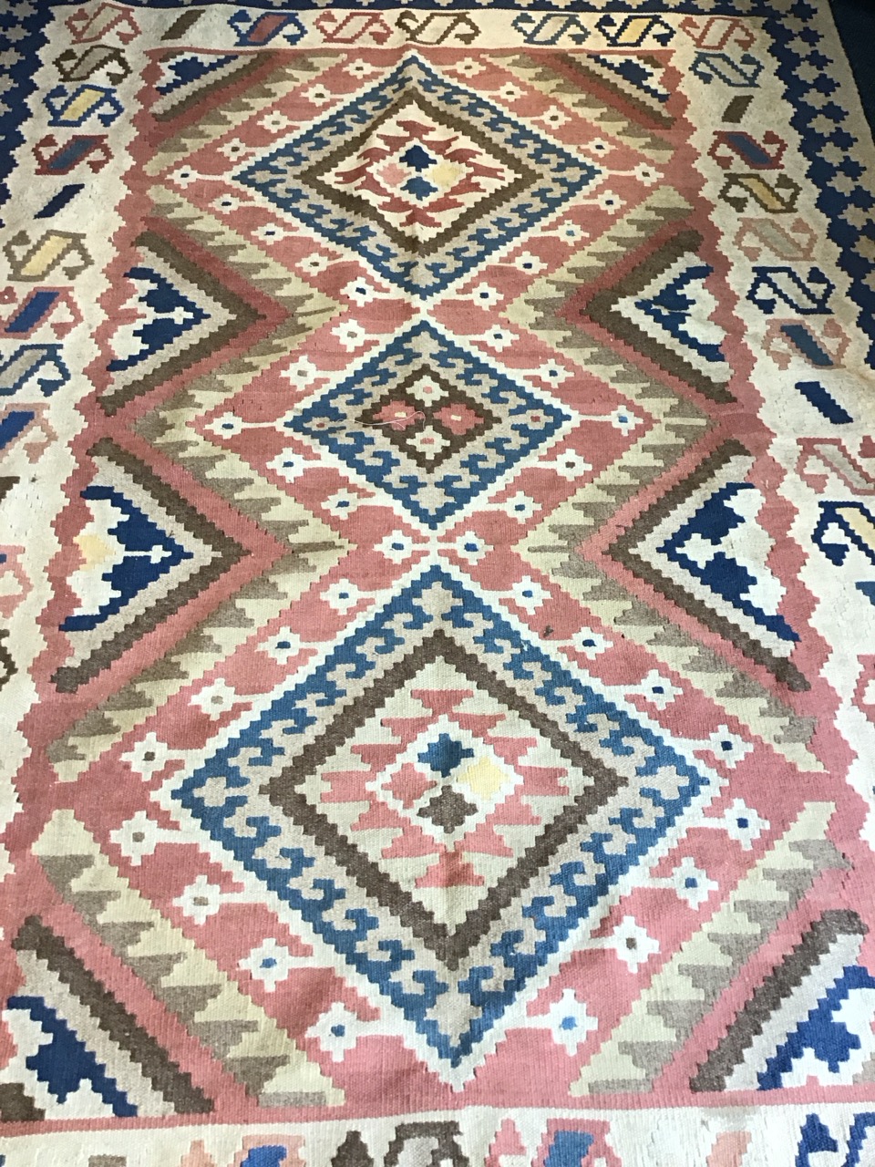An Anatolian wool kilim carpet with three hooked lozenge medallions on a pink field within repeating - Image 2 of 3