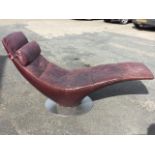 A 60s modernist Italian leather upholstered chaise with rectangular backrest and tapering