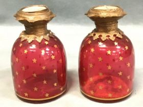A pair of Victorian cranberry glass Palais Royal scent bottles of domed form having giltmetal