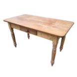 A Victorian pine table with rectangular rounded top above a frieze with knobbed drawer, raised on
