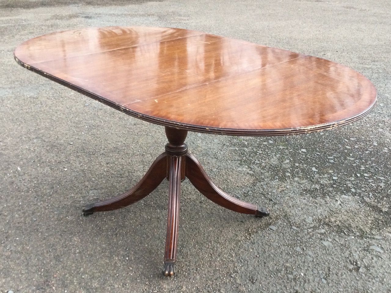 A Georgian style mahogany dropleaf dining table, the crossbanded top with two demi-lune leaves - Image 2 of 3