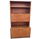 A 1970s teak bureau bookcase with rectangular open-shelf top above a fall-front desk with recessed