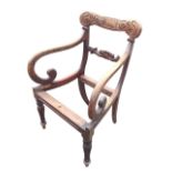 A William IV mahogany armchair with carved back and joining rail, having scrolled arms raised on