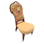 A Victorian mahogany chair with floral woolwork upholstered spoon back above a rounded sprung