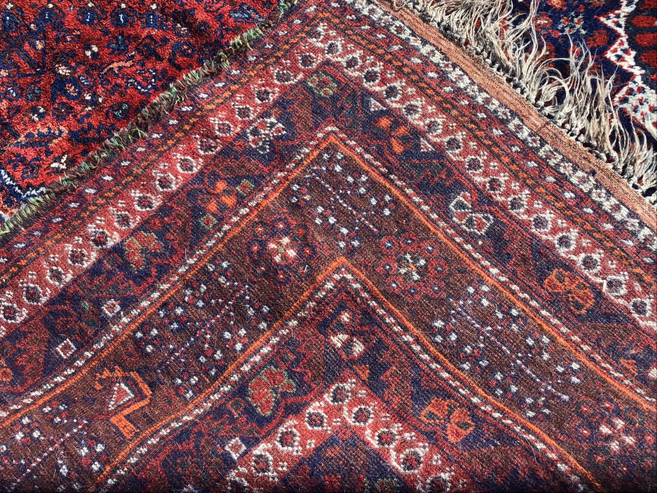 A Shiraz wool carpet with flowerhead lozenge medallion amid profuse flowers on a red field with - Image 3 of 3