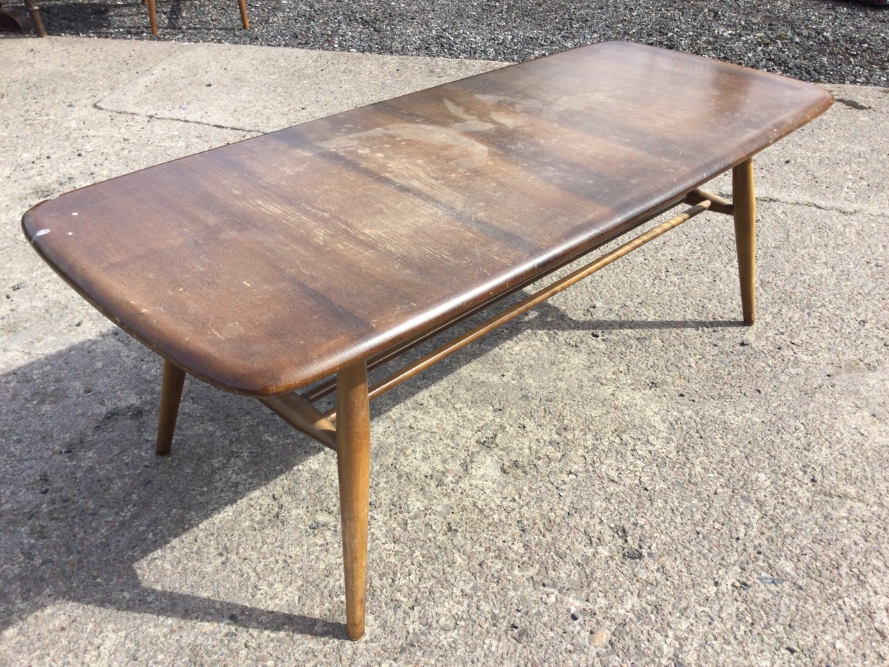 An Ercol elm & beech coffee table with rounded rectangular top raised on turned legs joined by a - Image 3 of 3