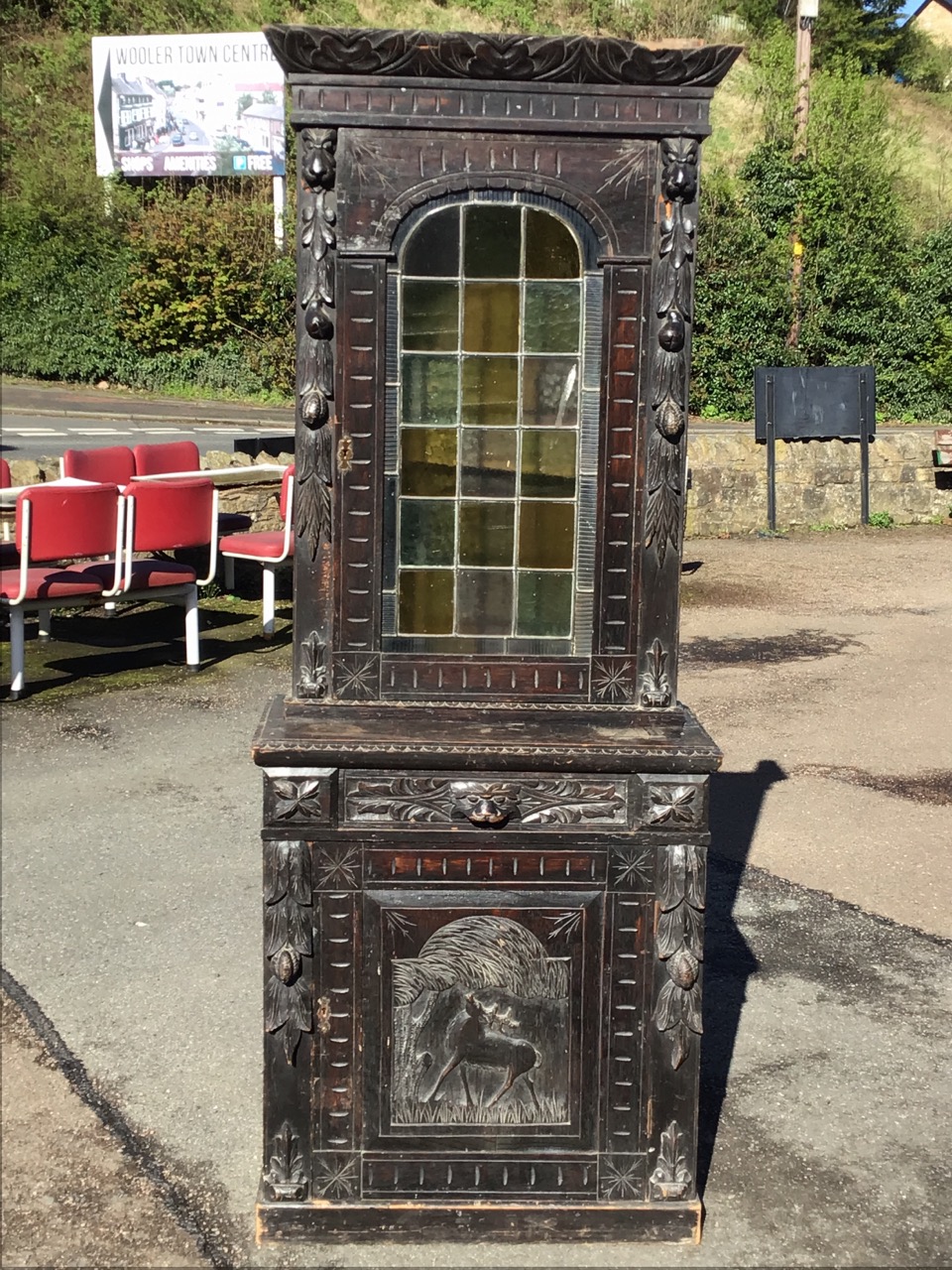 A Victorian oak carved cabinet with leaf carved cornice above an arched leaded glass door flanked by - Image 2 of 3