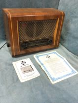 A 50s walnut cased Pye valve radio - model P75T with glass dial beneath fabric covered speaker,