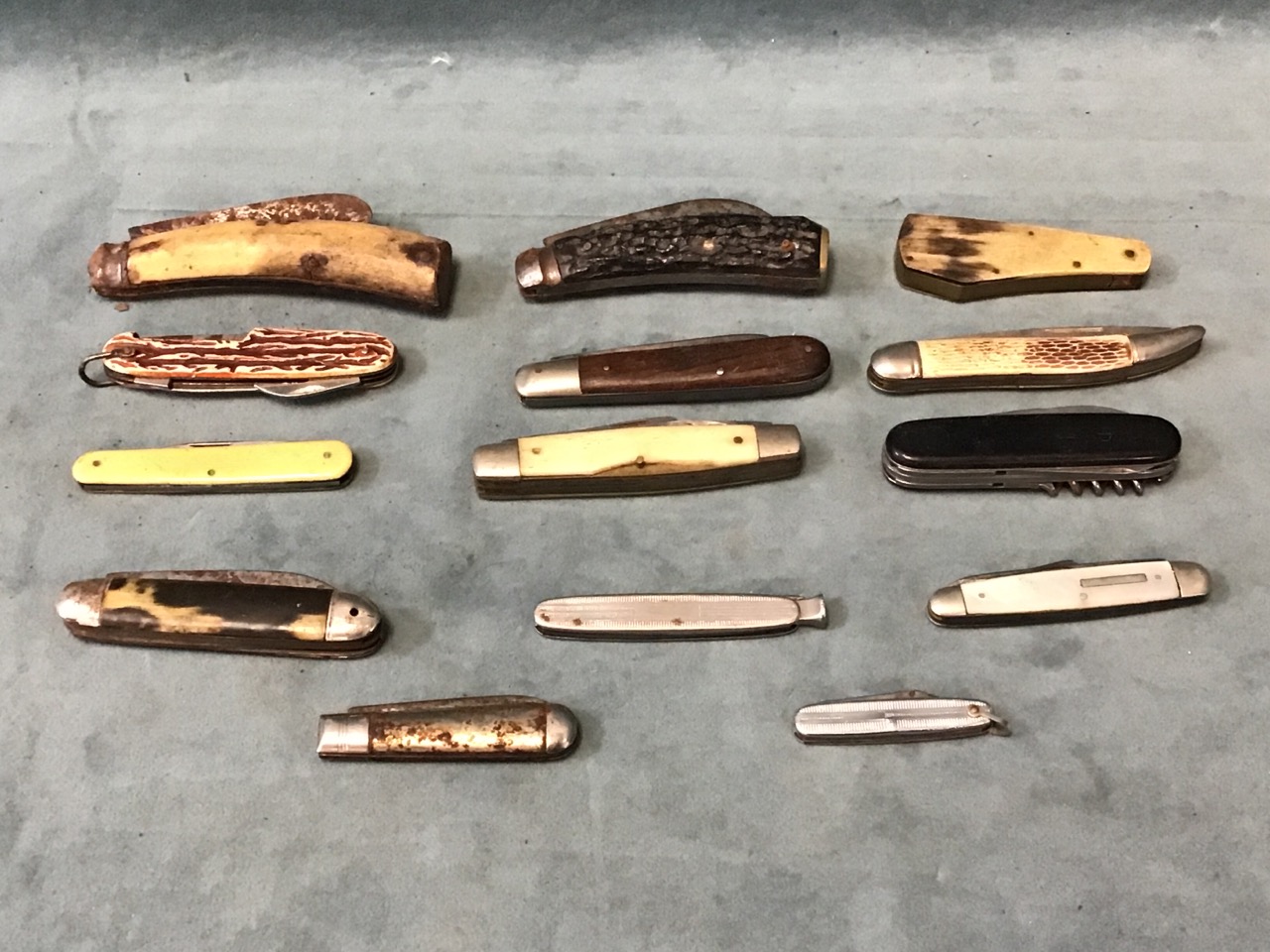 A collection of penknives - bone, antler horn, mother-of-pearl, wood and steel handled examples, a