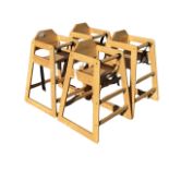 Four contemporary hardwood stacking high chairs, the solid backs and seats with retaining bars and
