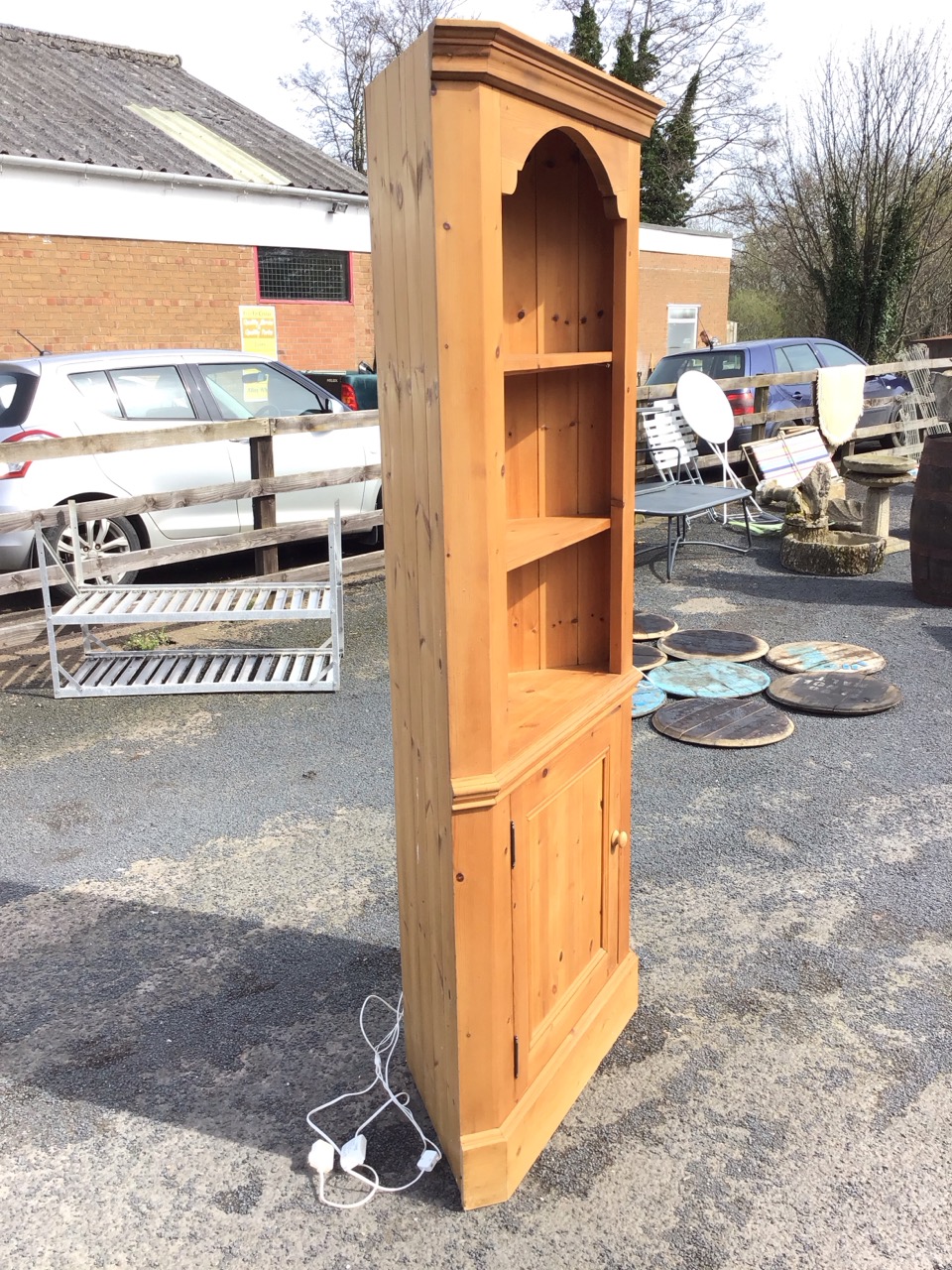 A Victorian style pine corner cabinet with moulded cornice above open shelves and a knobbed - Image 2 of 3