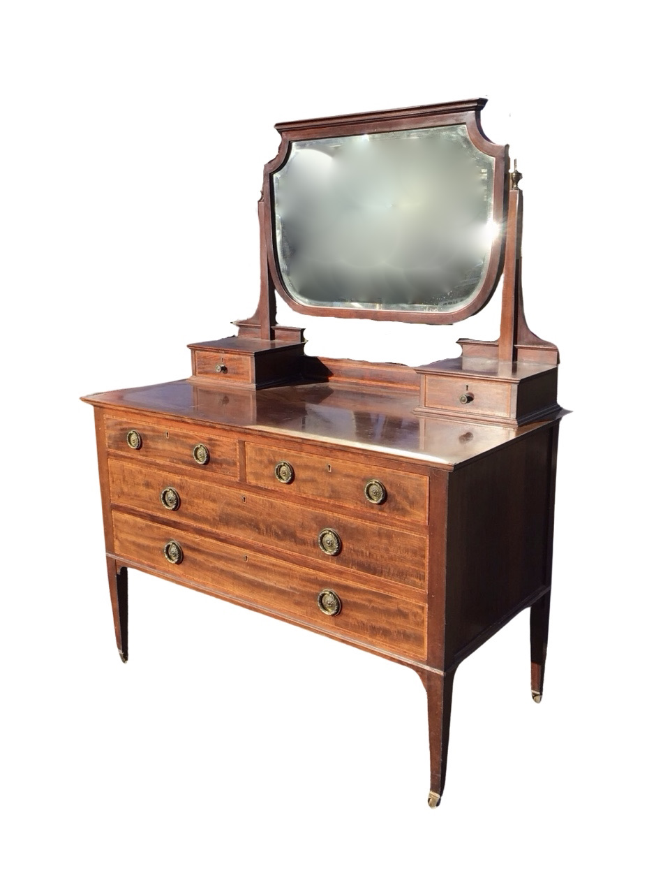 An Edwardian satinwood crossbanded mahogany dressing table, the bevelled mirror on tapering square