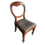 A Victorian mahogany balloon back chair with a drop-in upholstered seat on moulded rails, raised