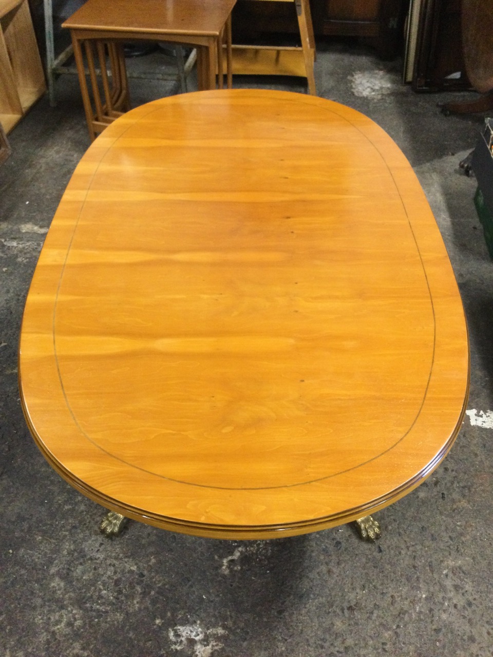 A regency style yew coffee table with moulded oval mahogany strung top on a turned column, raised on - Image 2 of 3