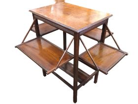 An Edwardian mahogany occasional table with rectangular moulded top above four fold-out trays raised