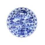 A large Chinese blue and white circular scalloped charger decorated with children in a garden amid