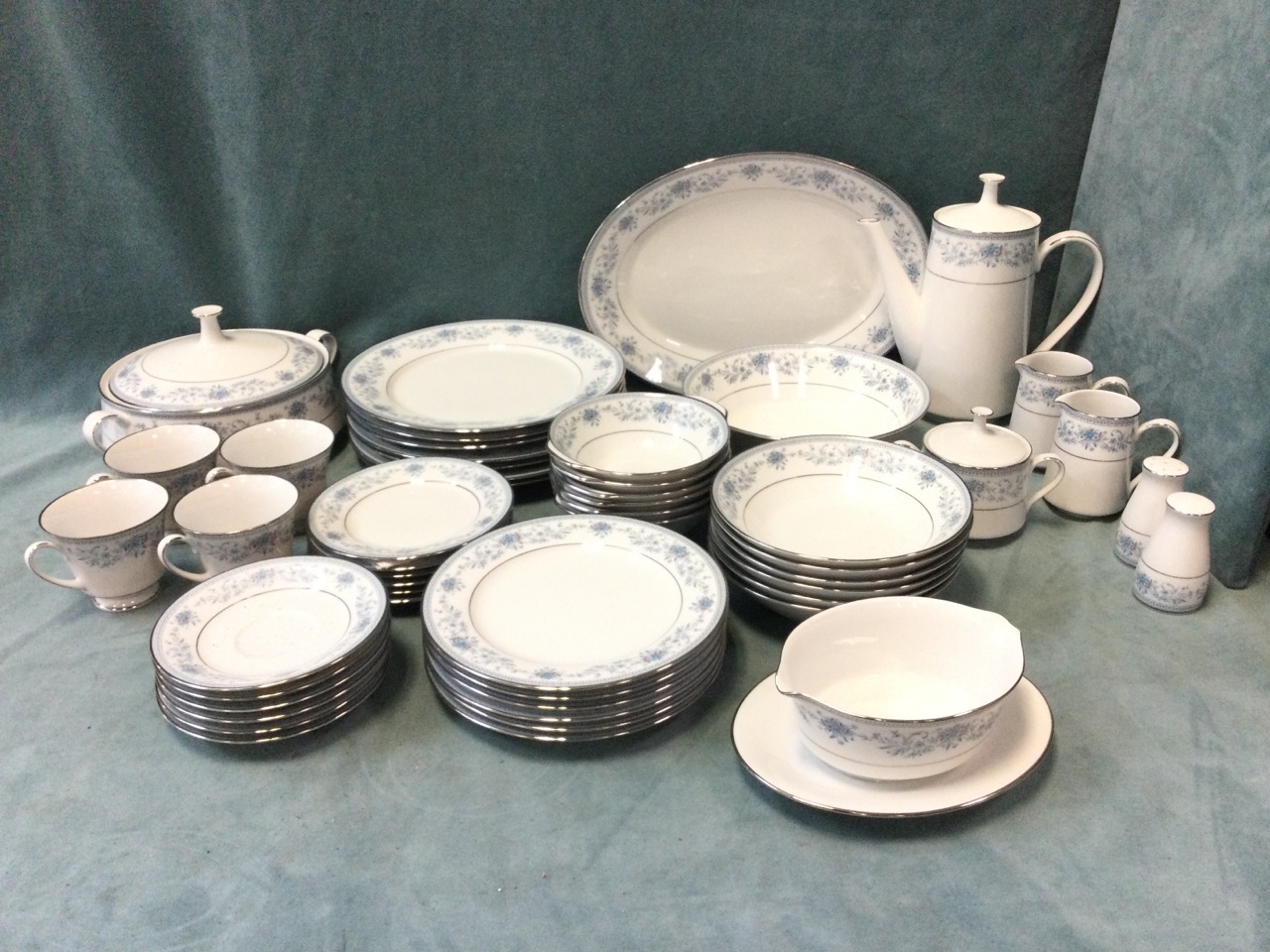 An extensive Noritake porcelain dinner service in the Blue Hill pattern with a covered tureen, an