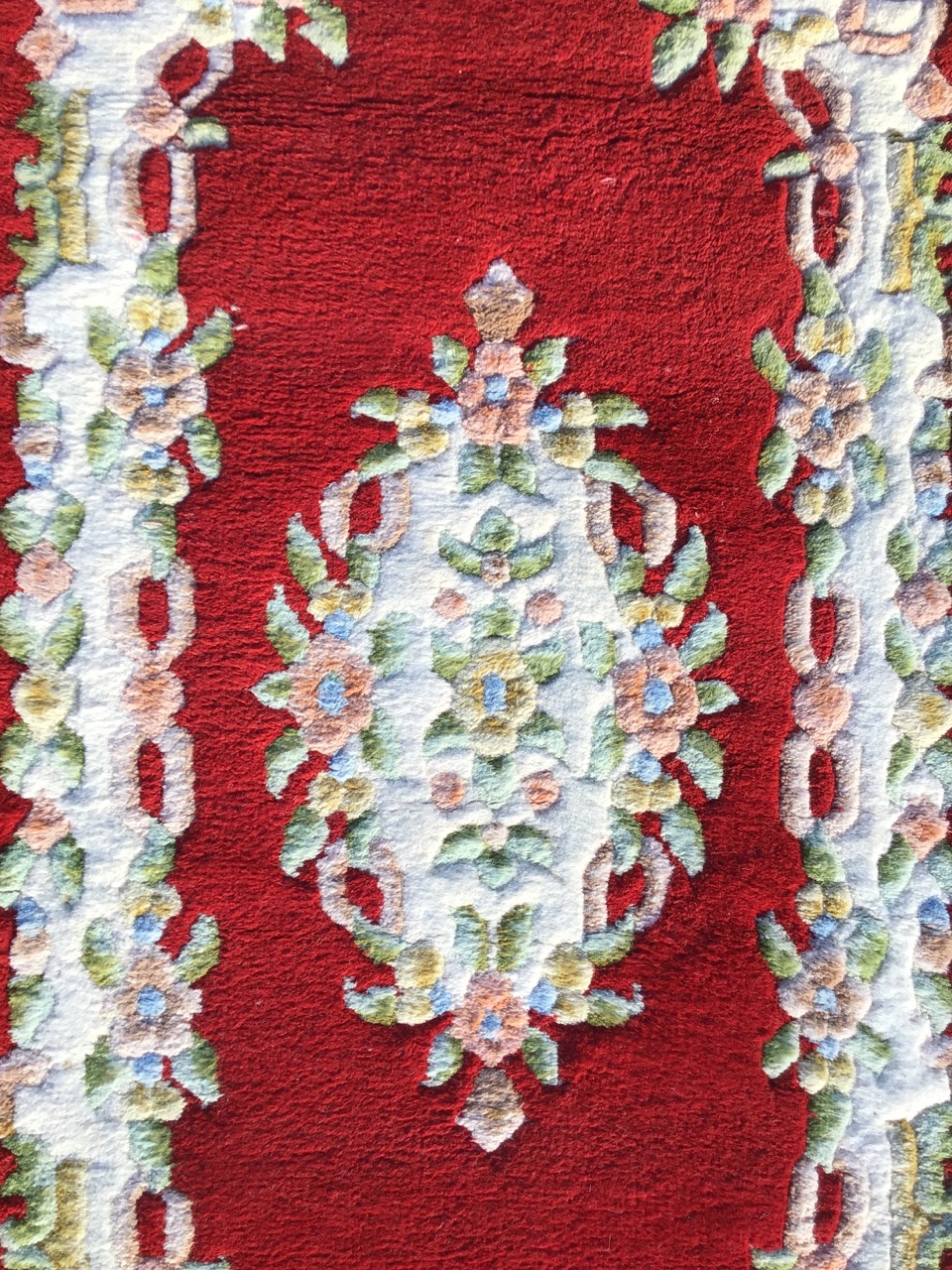 An Indian aubusson style rug with floral medallion on red ground within conforming floral - Image 2 of 3