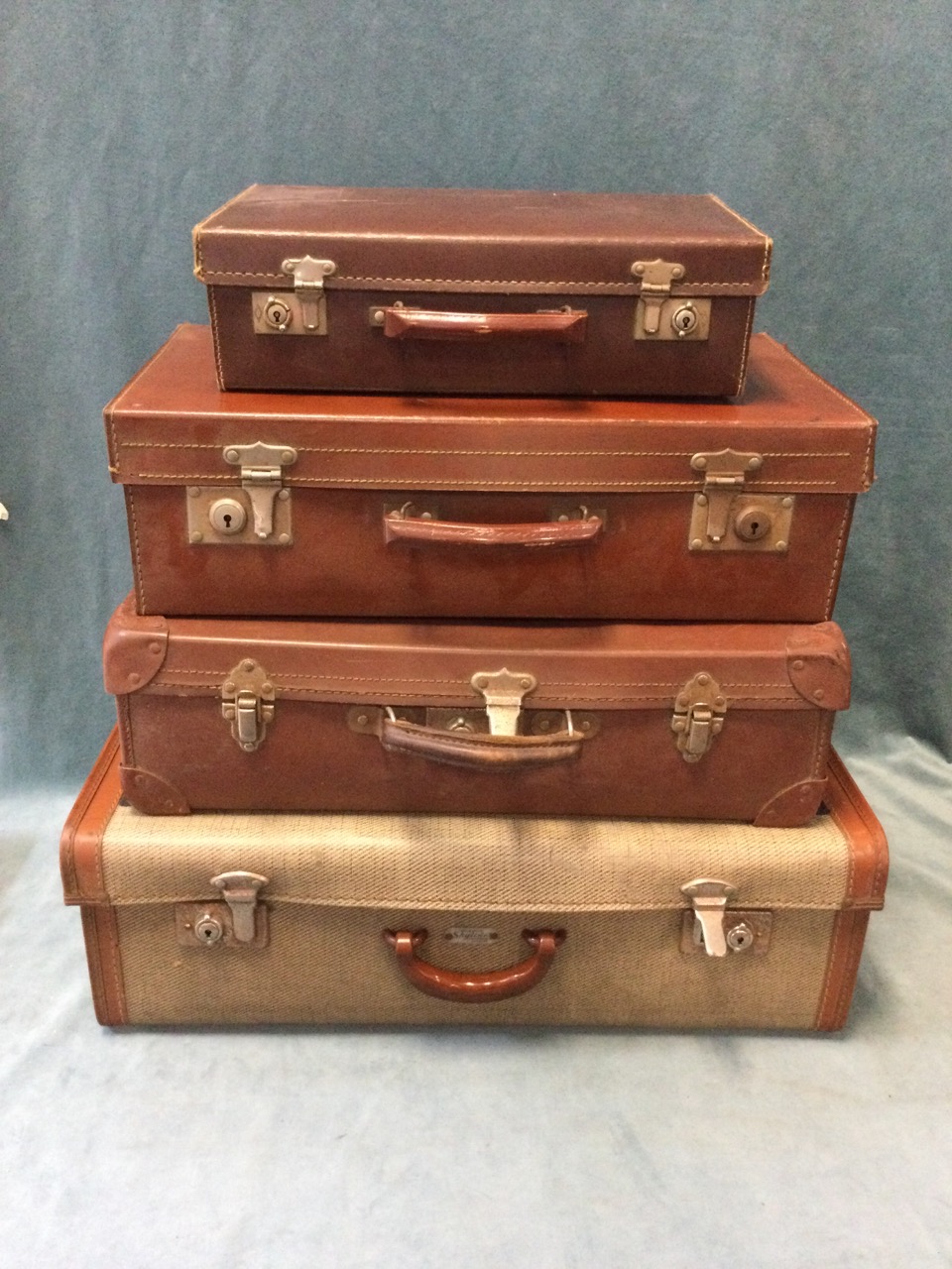 Four miscellaneous C20th suitcases. (4)