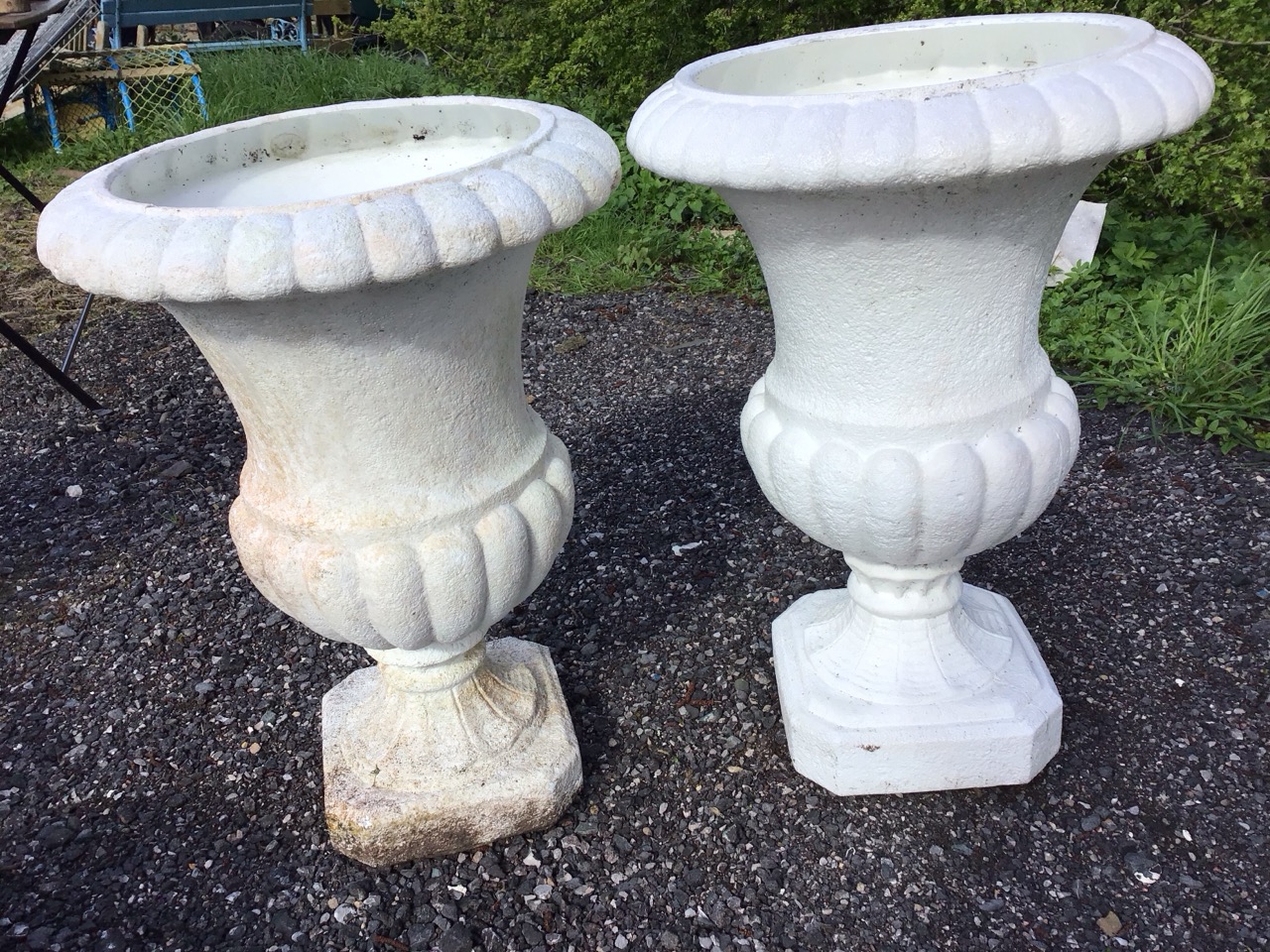 A pair of classical shaped plastic lobbed garden urns on square canted plinths; a large ribbed - Image 3 of 3