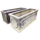 A pair of rectangular faux lead garden troughs with moulded plinths and rims, having panelled sides.